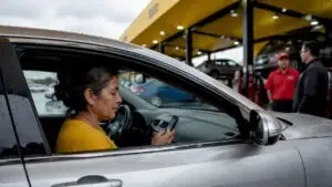 Woman scheduling same day oil change on phone