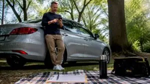 Man scheduling car maintenance on smartphone