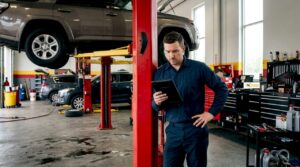 Technician reviewing service categories near vehicle
