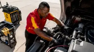 Mechanic inspecting fleet truck engine