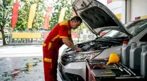 Mechanic performing quick oil change on car