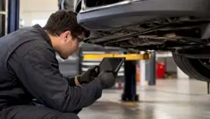Technician using tablet for vehicle inspection