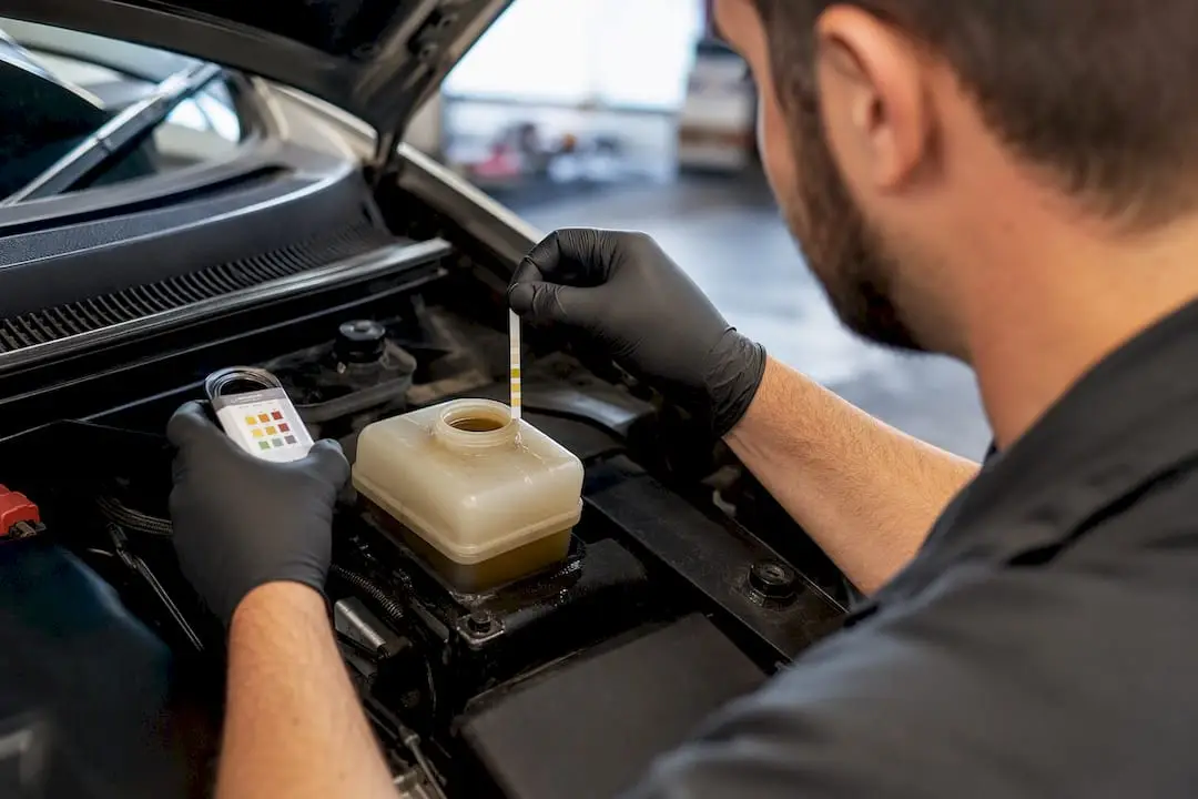 Technician testing brake fluid moisture