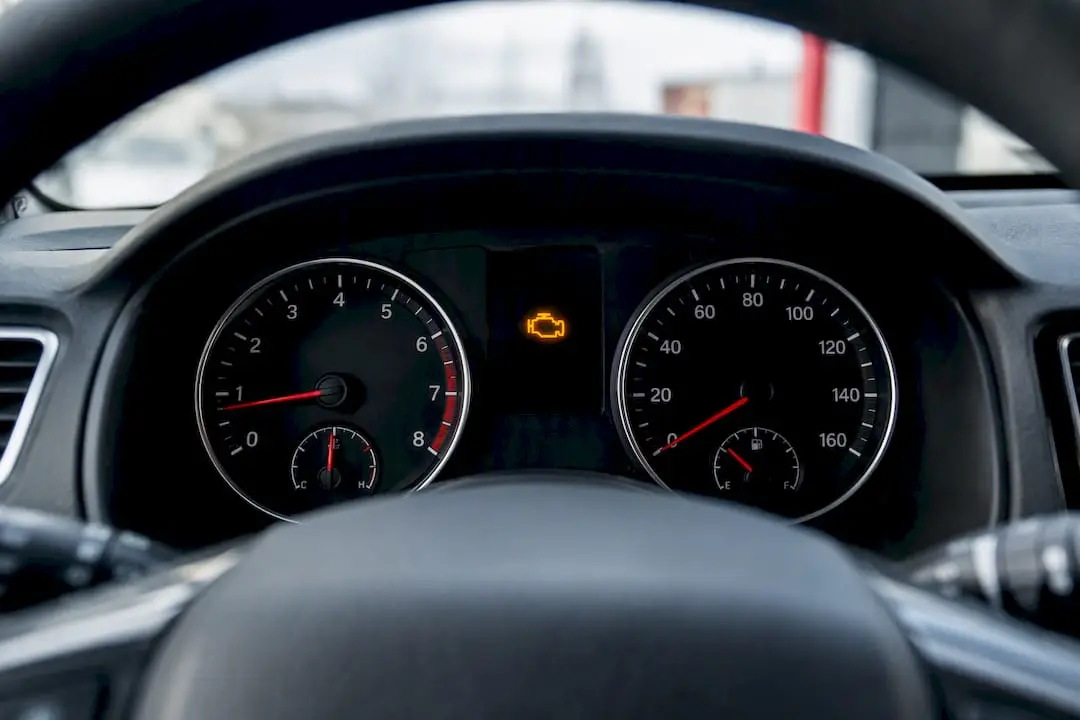 Close dashboard with flashing engine warning light