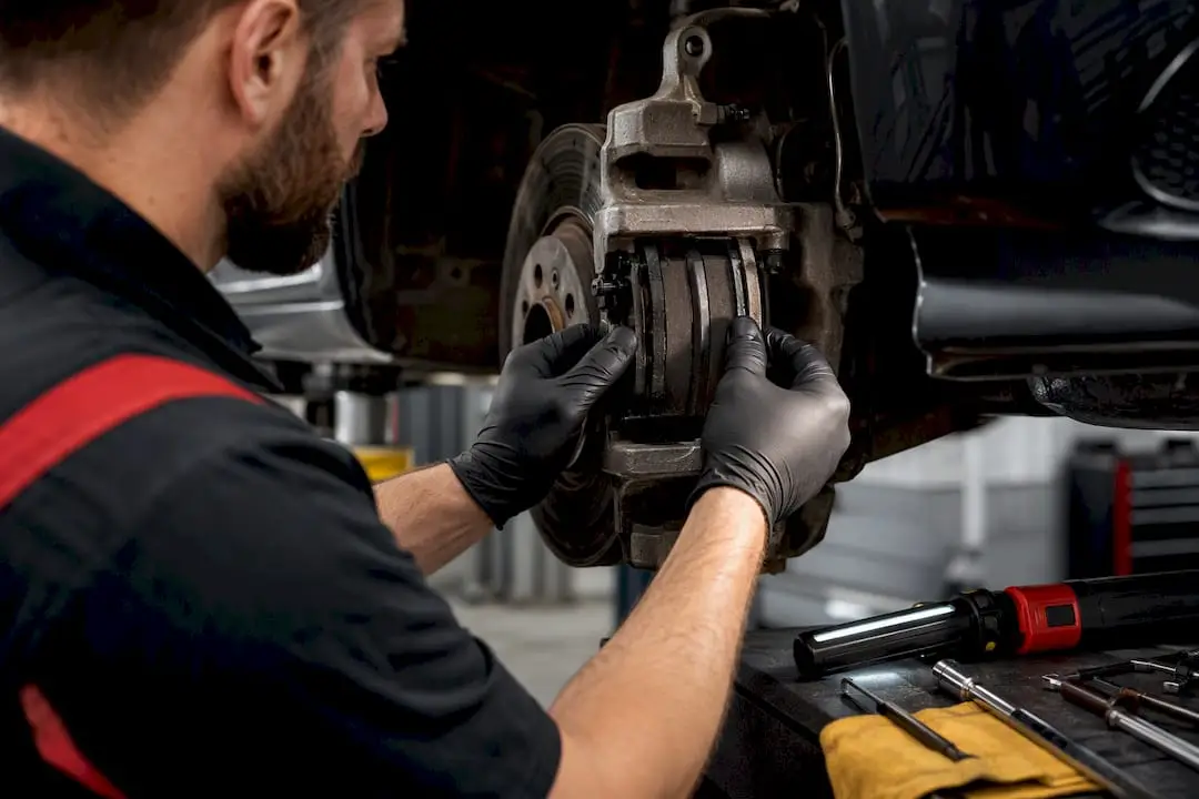 Technician inspecting a vehicle brake assembly