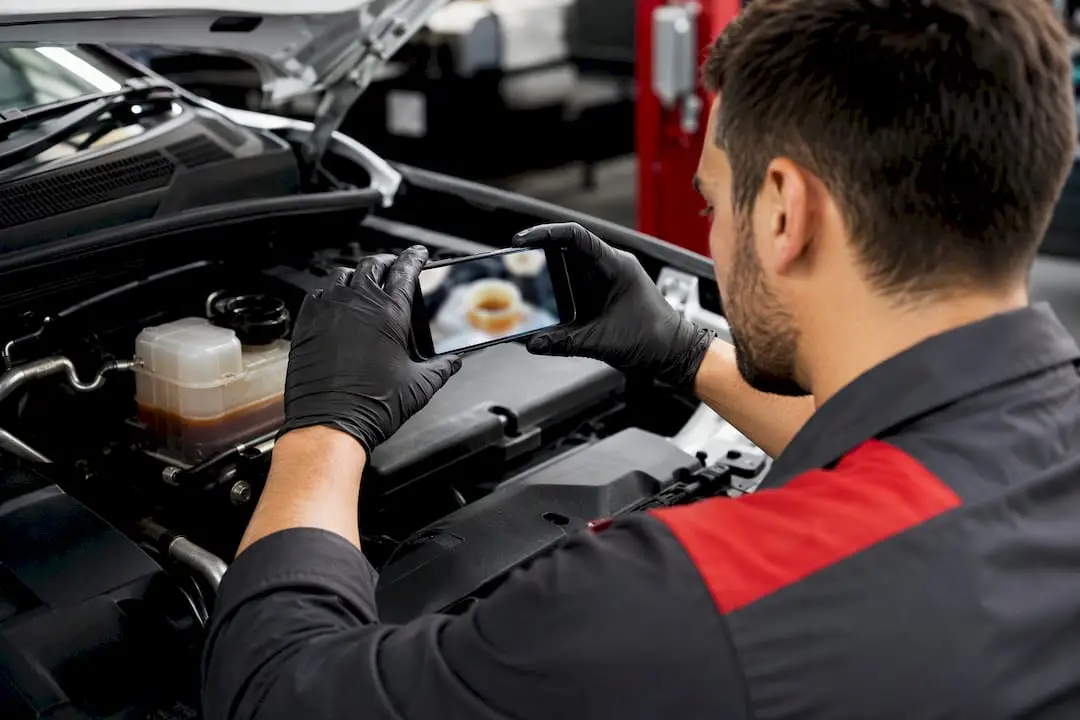 Technician documenting a vehicle fluid inspection